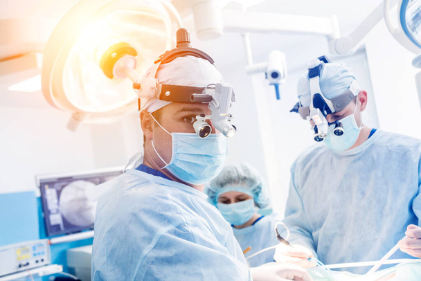 Portrait of spinal surgeon in operating room with surgery equipment. - Фото, зображення