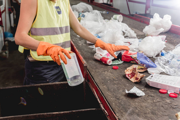 Worker separating garbage collection at modern recycling plant - Φωτογραφία, εικόνα
