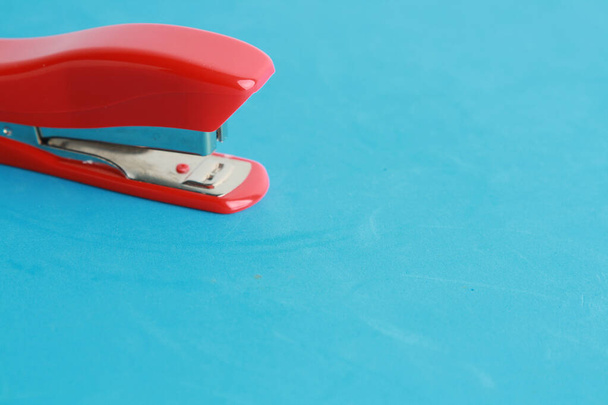 red stapler in color background - Photo, Image