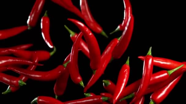 Super slow motion of flying red hot chilli peppers with speed ramping effect. Filmed on high speed camera, 1000 fps - Video, Çekim