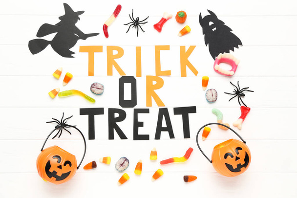Text Trick or Treat with paper halloween decorations and candies - Zdjęcie, obraz