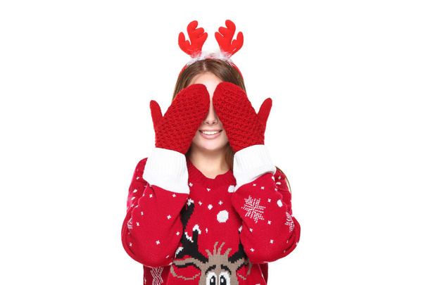 Beautiful woman wearing christmas sweater, gloves, red horns and - Photo, image