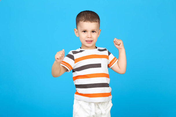 Cute little boy on blue background - Фото, зображення