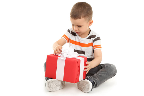 Cute little boy with gift box isolated on white background - Φωτογραφία, εικόνα