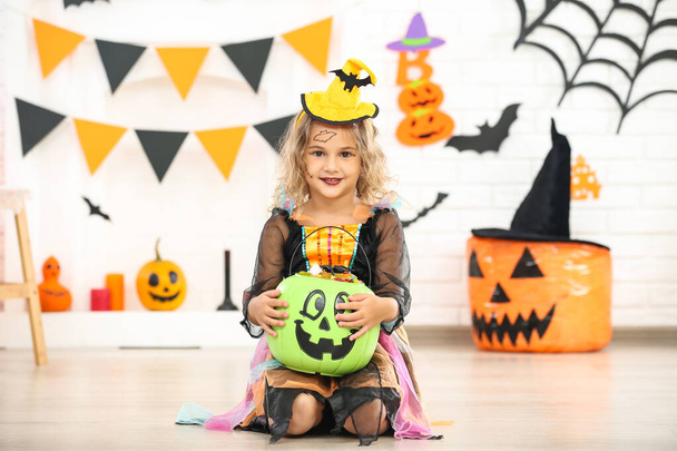 Young girl in halloween costume holding pumpkin bucket with cand - Zdjęcie, obraz