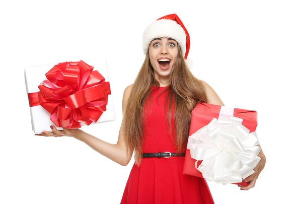 Beautiful woman wearing santa hat and holding gift boxes on whit - Foto, Bild