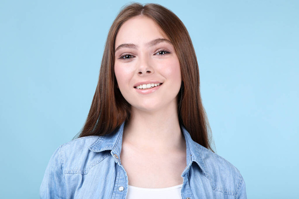 Young beautiful woman on blue background - Foto, Imagen