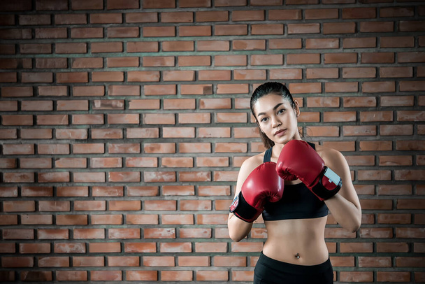 Asian sport woman wear boxing glove  in the gym,Thailand people workout,The best of fighther,Strong woman - Fotografie, Obrázek