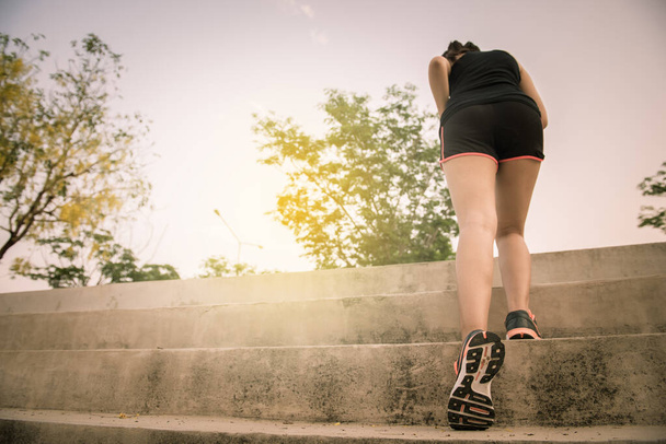 Asian slim woman run on stair - Фото, изображение