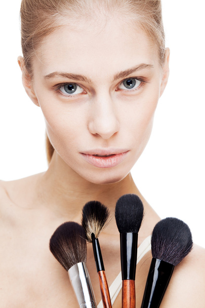 Young blond woman holding cosmetics brushes - Фото, зображення