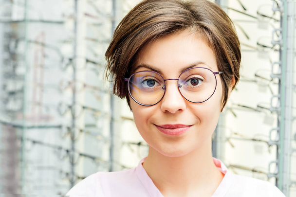 Portrait of smiling female customer wearing glasses in store - Foto, Imagem
