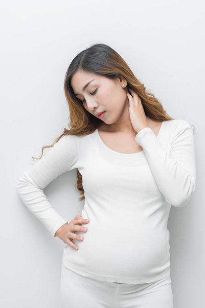 A pregnant woman in white dress stand pose for take a picture on white background - Foto, imagen