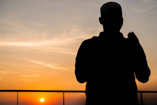 Silhouette Young asian muslim man praying on sunset,Ramadan festival concept - Photo, Image