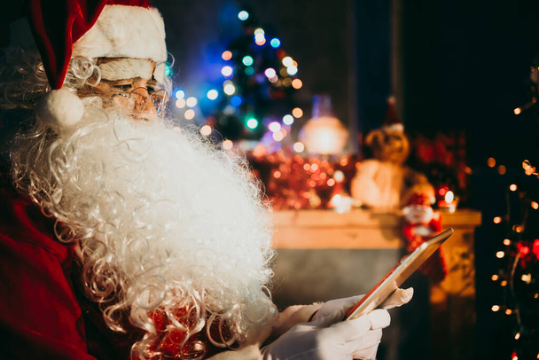 Santa Claus playing on tablet, Merry christmas concept - Fotografie, Obrázek