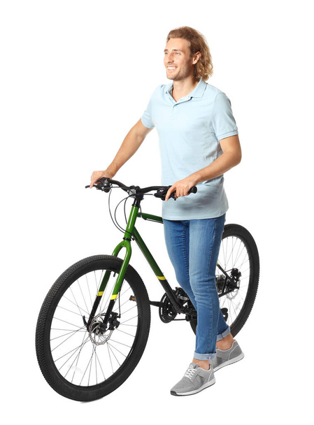 Happy young man with bicycle on white background - Photo, Image