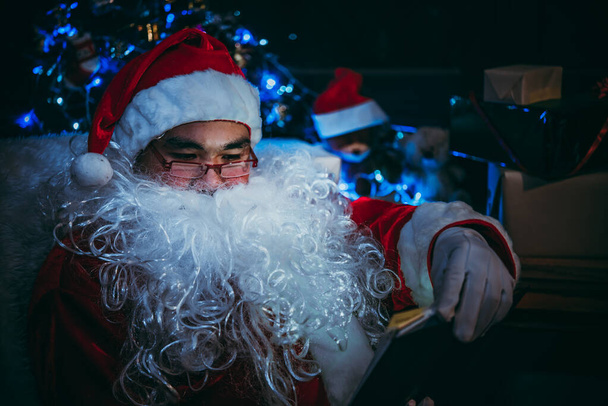 Portrait of Happy Santa clause reading book, Merry christmas concept - Photo, Image