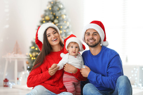Happy family with cute baby at home. Christmas celebration - Φωτογραφία, εικόνα