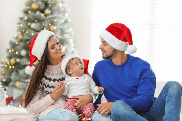 Happy family with cute baby at home. Christmas celebration - Fotoğraf, Görsel