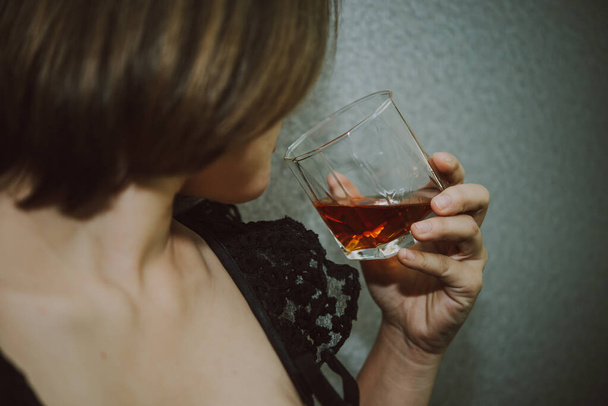 Asian woman broken heart with whiskey in hand on vintage style,she heart break from love,sad woman concept - Фото, изображение
