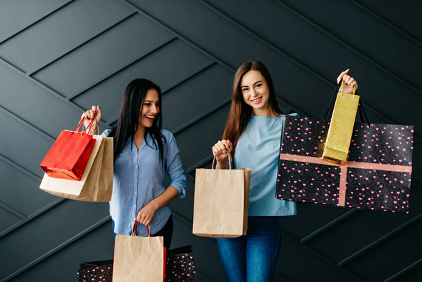 Two happy women enjoy shopping, black friday concept - Foto, Imagem