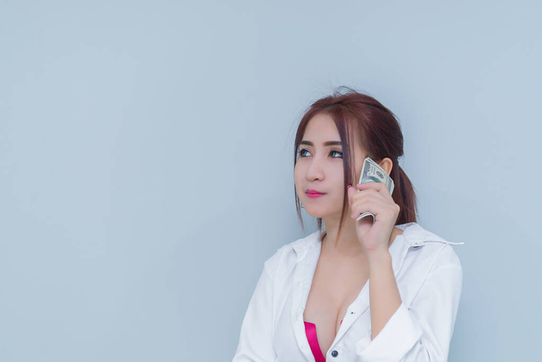 Portrait of asian sexy woman with a lot of money on white background,thailand people,The rich business woman concept - Foto, afbeelding