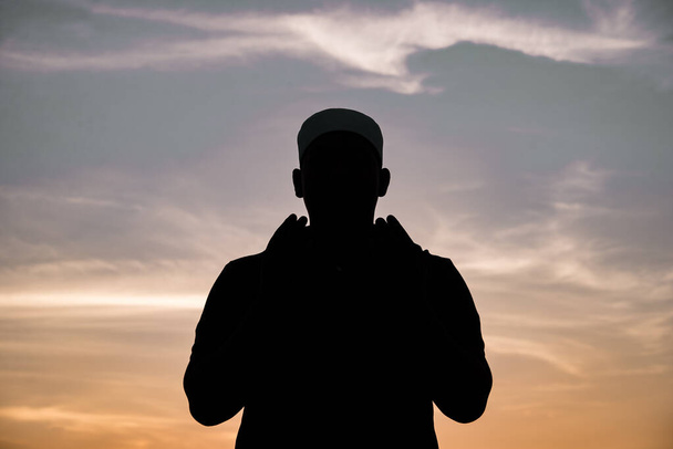 Silhouette Young asian muslim man praying on sunset,Ramadan festival concept - Fotografie, Obrázek