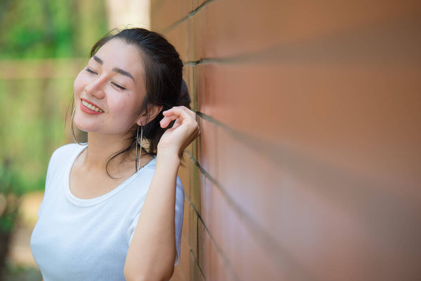 Portrait of beautiful asian chic girl pose for take a picture on brick wall,Lifestyle of teen thailand people,Modern woman happy concept - Photo, image