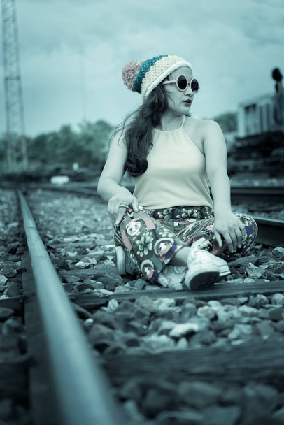 Hipster asian fat girl pose for take a photo,Fashion portrait pretty woman at railway,lifestyle of modern teenage thai girl,Colorful cloths,thailand people - Zdjęcie, obraz