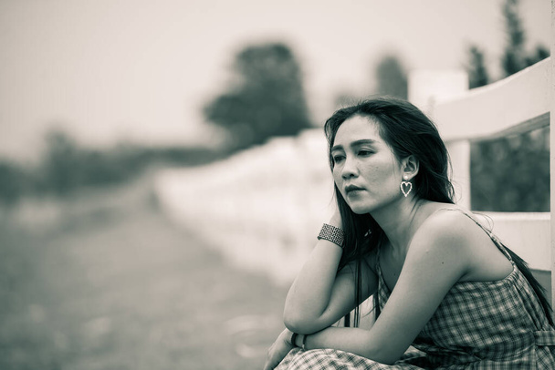 Beautiful thai woman very sad from unrequited love,dark tone,Asian girl broken heart,A boy friend has a new love - Фото, зображення