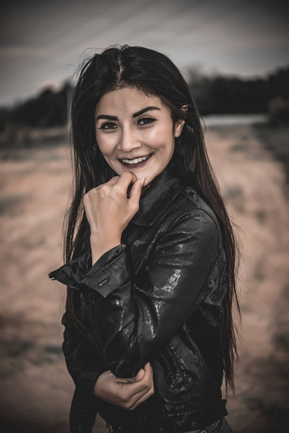 Asian woman wearing black leather meadow in the field darktone,The lifestyle of a woman biker - Valokuva, kuva
