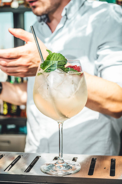Bartender mixing alcoholic cocktail at the bar  - Photo, Image