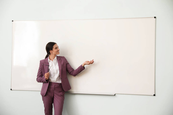 Female teacher near whiteboard in modern classroom - Fotografie, Obrázek