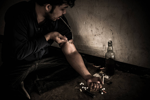 Asian men are drug addicts to inject heroin into their veins themselves.Flakka drug or zombie drug is dangerous life-threatening,Thailand no to drug concept,The bad guy drugs in the desolate - Фото, зображення