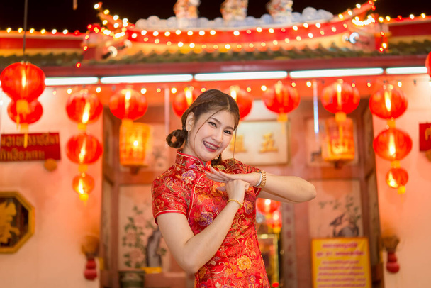 Portrait of beautiful asian woman wear cheongsam on light of lantern background,Happy chinese new year,Thailand people - Foto, immagini
