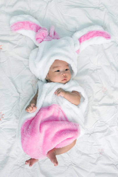 Close up cute asian baby girl in a rabbit dress - Valokuva, kuva