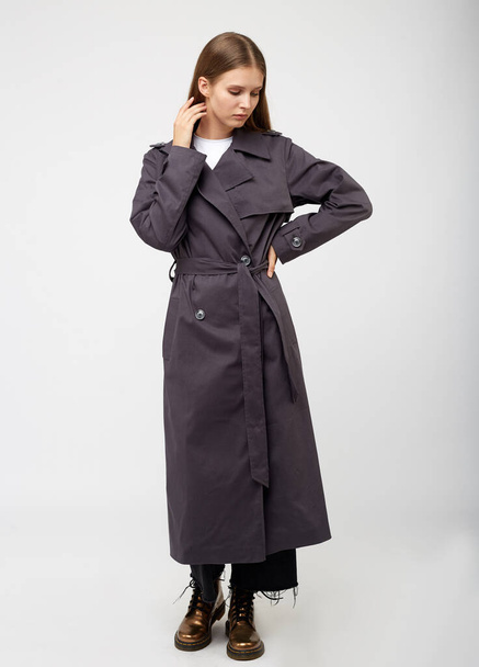 Female trench coat. Charcoal color. Isolated on white background. - 写真・画像