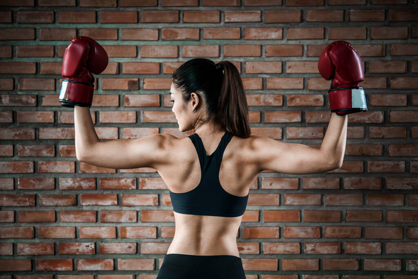 Asian sport woman wear boxing glove  in the gym,Thailand people workout,The best of fighther,Strong woman - Φωτογραφία, εικόνα