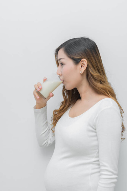 Pregnant woman with milk in her hand, Drinking milk good health to pregnancy - Фото, изображение