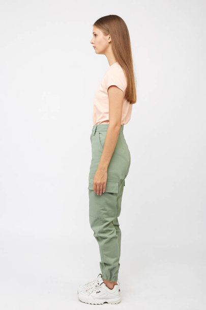 girl in green cargo pants and a t-shirt - 写真・画像