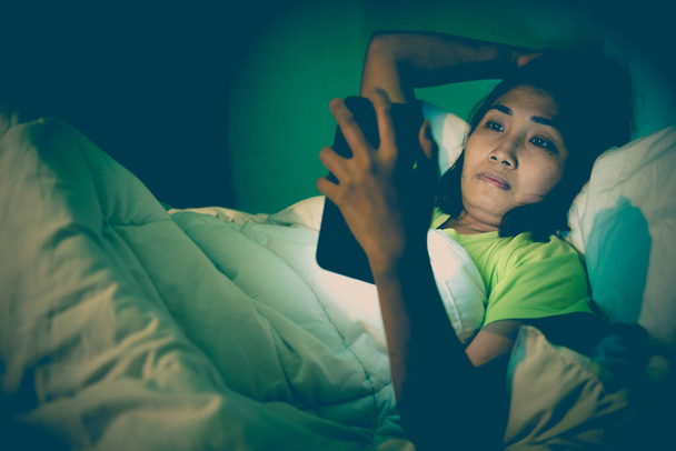 Asian woman play smartphone in the bed at night,Thailand people,Addict social media,Play internet all night - Fotoğraf, Görsel