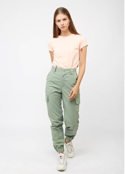 girl in green cargo pants and a t-shirt - Zdjęcie, obraz