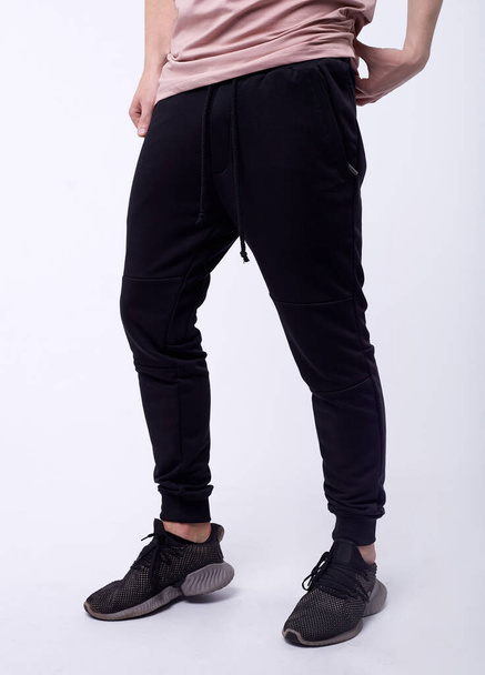 man in jeans, denim pants close up on white background, black jeans. - Foto, Imagem