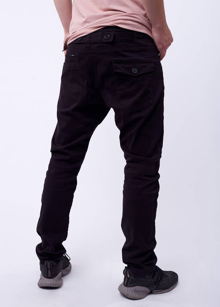 man in jeans, denim pants close up on white background, black jeans. - Fotó, kép