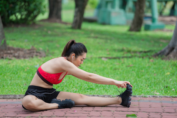 Asian sporty woman stretching body breathing fresh air in the park,Thailand people,Fitness and  exercise concept,Jogging in the park - Fotografie, Obrázek