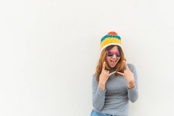 Portrait of hipster girl on white wall,lifestyle of modern teen - Fotó, kép