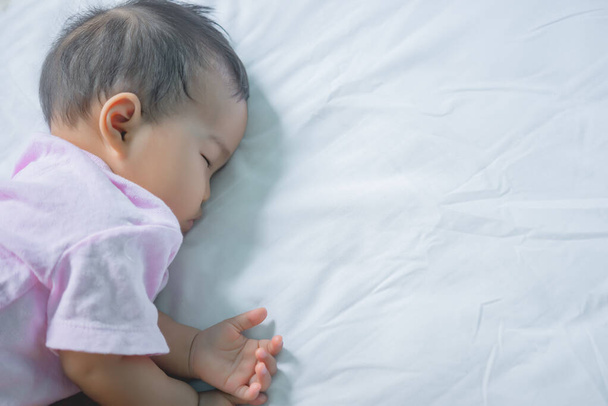 Asian baby sleeping on the bed,thailand people,relax time - Фото, изображение