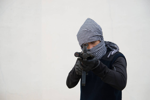 Close up terrorist with gun on white background,Thailand people,A bad guy,He is no good man - Foto, Imagen