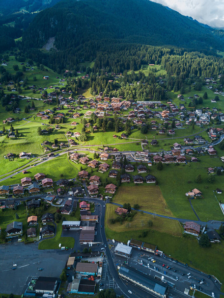 Sun shines over Swiss village Grindelwald after heavy storm in summer time near Swiss Alps - Photo, Image