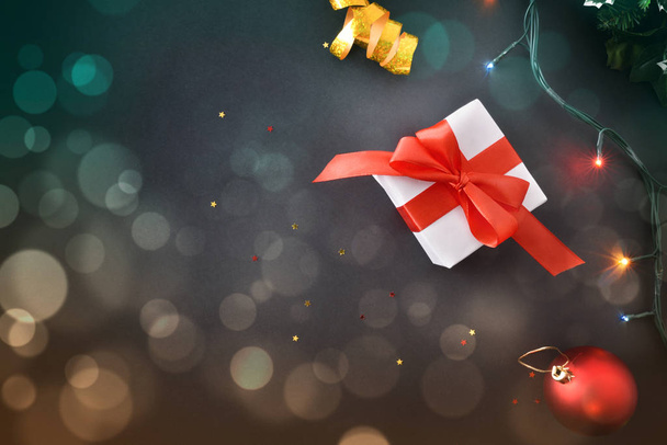 Christmas background with gifts and colored lights on black top - Photo, Image
