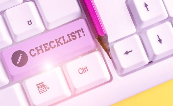 Text sign showing Checklist. Conceptual photo list items required things be done or points considered White pc keyboard with empty note paper above white background key copy space. - Photo, Image